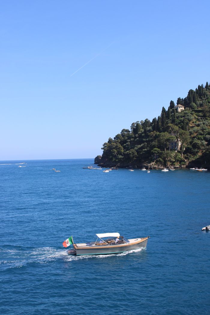 A picturesque boat ride along the stunning Portofino coastline on a sunny day in Liguria, Italy.
